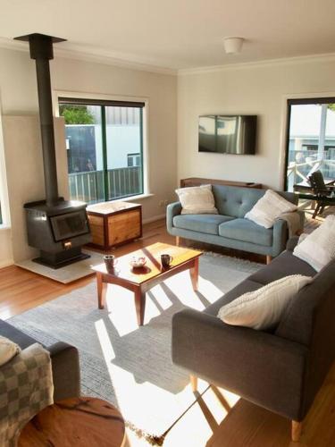 a living room with a couch and a stove at Town Hideaway - Sleeps 6 in Margaret River Town