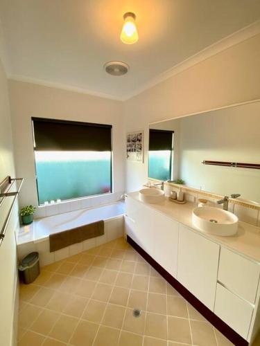 a bathroom with two sinks and a large window at Town Hideaway - Sleeps 6 in Margaret River Town