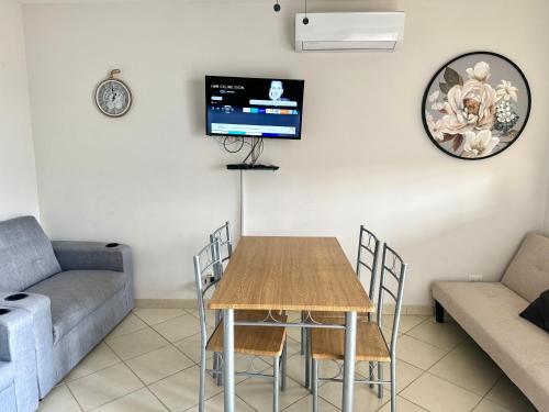 a living room with a table and a couch at Charming Condo With A Rooftop, Across Beach in Coco