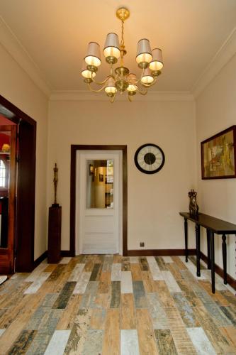 an empty living room with a chandelier and a door at The Citizen in Antananarivo