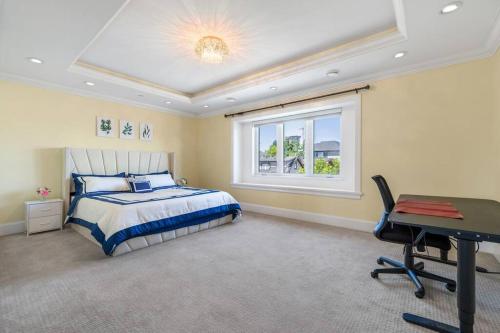 a bedroom with a bed and a desk and a window at Luxury 4-Bedroom Family Home in Vancouver