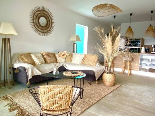 a living room with a couch and a table at Ti Pêcheurs vb Bord de mer in Saint-Pierre