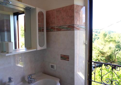 a bathroom with a sink and a window at Eden - Nel Cuore Della Natura in Compignano