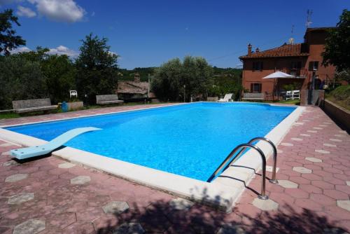 a swimming pool with a stairway leading to a house at Eden - Nel Cuore Della Natura in Compignano