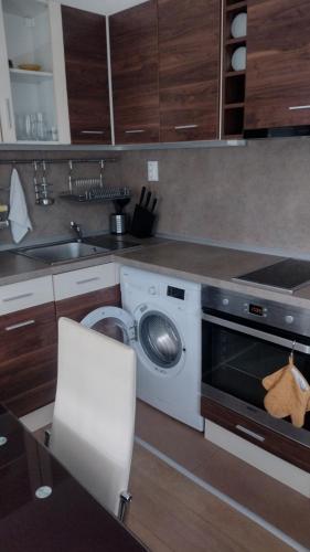 a kitchen with a washing machine and a sink at ЕкоПойнт in Chernomorets