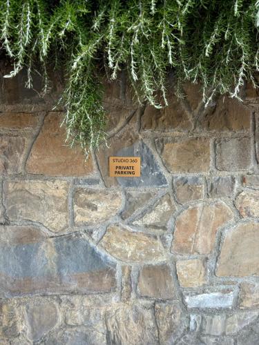 a sign on a stone wall with a sign on it at Studio 360 in Portorož