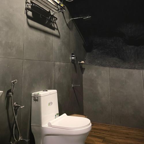 a bathroom with a white toilet in a room at Kap Korome Village Resort in Koroth