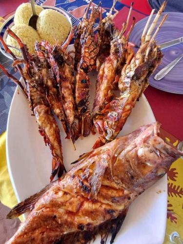 a plate of food with lobsters and other foods at Ô Bleu Azur in Antsatrakolo