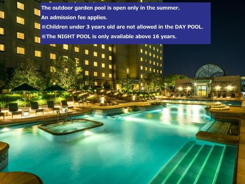 a large swimming pool at night with lights at Hotel East 21 Tokyo in Tokyo