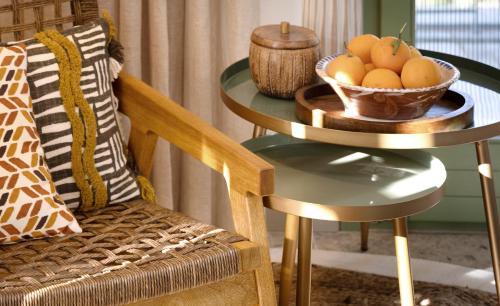 a bowl of fruit on a table next to a chair at Pelikastri in Promírion