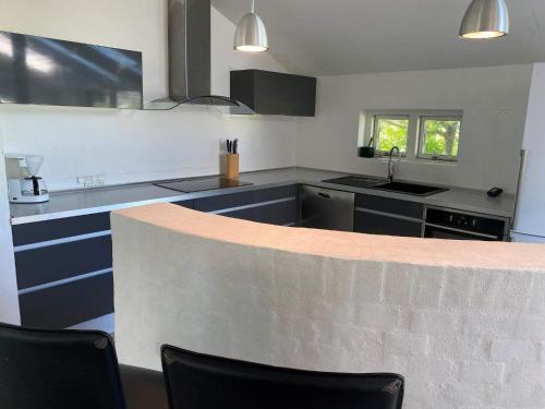 a kitchen with blue cabinets and a counter top at Light-filled Retreat in Boddum - By Traum Ferienwohnungen in Boddum
