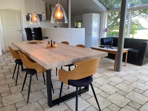 a dining room with a wooden table and chairs at Light-filled Retreat in Boddum - By Traum Ferienwohnungen in Boddum