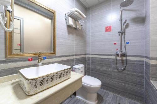 a bathroom with a sink and a toilet and a shower at 万象莉莉酒店 Lilyhotel in Vientiane