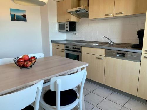 a kitchen with a table with a bowl of fruit on it at Haus Delbar in Bodman-Ludwigshafen