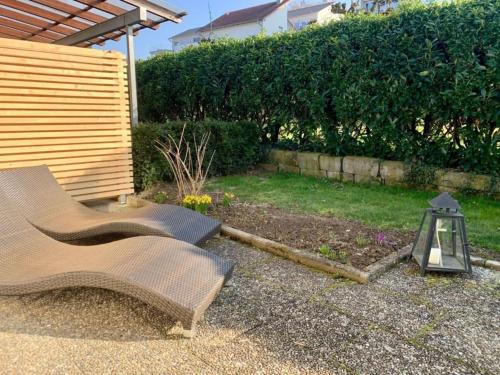 a garden with a bench and a lantern in a yard at Haus Delbar in Bodman-Ludwigshafen