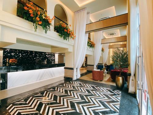 a lobby of a hotel with a geometric rug at Kastel Bangkok Hotel in Bangkok