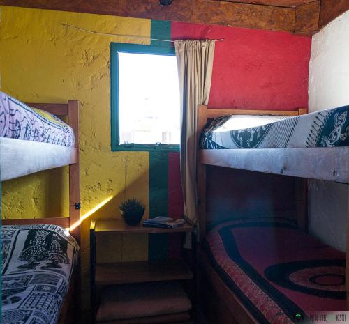 a room with two bunk beds and a window at Viejo Lobo in Cabo Polonio