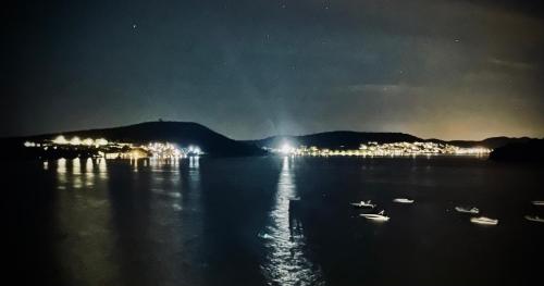 a view of a lake at night with boats in the water at Luxury apartment Betina in Betina