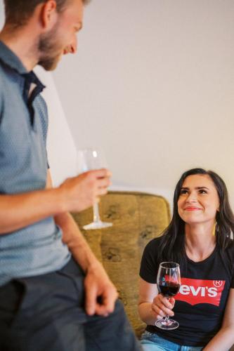 a man holding a glass of wine next to a woman at Wellness Penzion u Michala in Zuberec