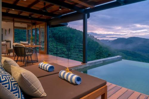 a house with a view of the mountains at Glenross Living - A Collection of 7 Private Pool Villas and 3 Colonial Suites in Kalutara