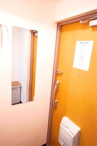 a bathroom with a toilet and a mirror at HOTEL AARON通天東 in Osaka