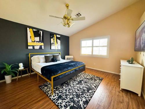 a bedroom with a bed and a ceiling fan at Spacious 4BR Fam Retreat King Bed WIFI And Parking in Las Vegas