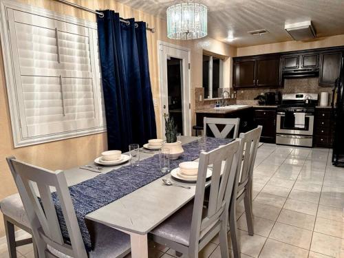 a dining room with a table and chairs in a kitchen at Spacious 4BR Fam Retreat King Bed WIFI And Parking in Las Vegas