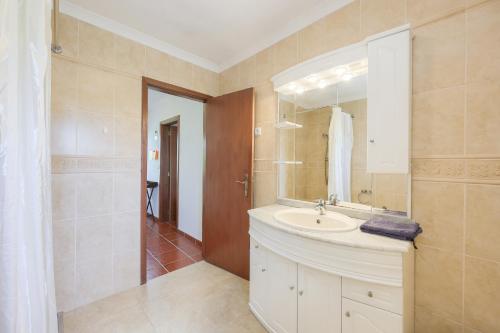 a bathroom with a sink and a mirror at Authentic apartment in rural area in Pindo