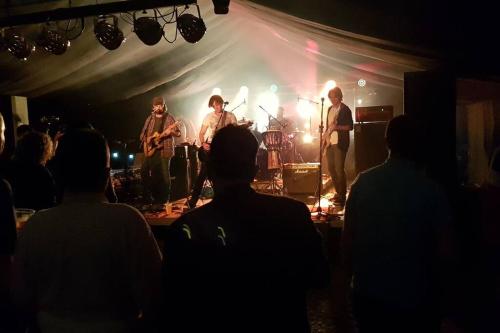 a group of musicians on a stage at a concert at Luminaire hosted accommodation in Guernsey