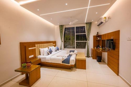 a bedroom with a bed and a window at S R Pool Suites in Mysore
