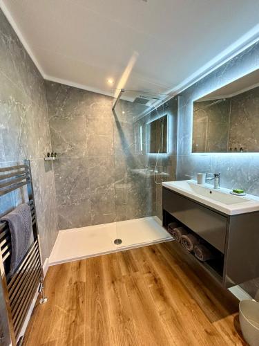 a bathroom with a sink and a mirror at Forest Hills Holidays in Coleford