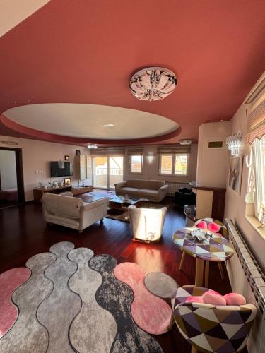 a living room filled with furniture and a chandelier at Orion Luxury Apartments in Bitola