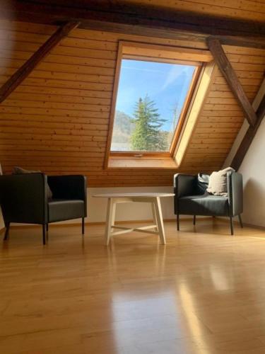 a room with two chairs and a table and a window at Haus Alkmene in Bodman-Ludwigshafen