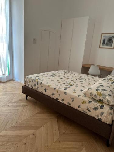 a bedroom with a bed with a comforter on it at Bellapulia apartments in Molfetta