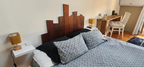 a bedroom with a large bed with pillows at A la maison de Sophie in Gignac