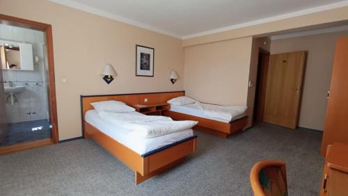 Postel nebo postele na pokoji v ubytování Hotel Delminium