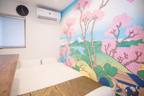 a bedroom with a mural of trees and animals at Traditional Japanese House, 100years, Renovated into Japanese art, Shinsekai in Osaka