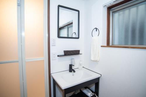 a bathroom with a sink and a mirror at Traditional Japanese House, 100years, Renovated into Japanese art, Shinsekai in Osaka