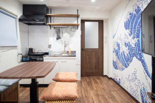 a small kitchen with a wooden table and a dining room at Traditional Japanese House, 100years, Renovated into Japanese art, Shinsekai in Osaka