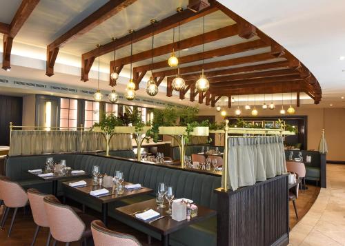 a restaurant with tables and chairs and a bar at Fota Island Hotel and Spa in Fota Island