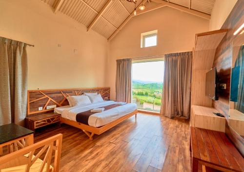 a bedroom with a large bed and a large window at AJ Gable Clouds Ooty by VOYE HOMES - Serene Stay Near Avalanche Emerald Lake in Ooty