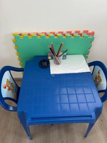 a blue and green table with pens and pencils at Relax Vendégház Tisza-tó in Poroszló