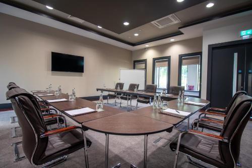a conference room with a long table and chairs at Fota Island Hotel and Spa in Fota Island
