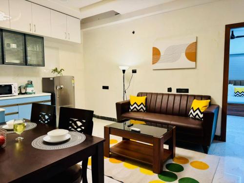 a living room with a couch and a table at BluO Penthouse Gachibowli - Terrace Garden in Hyderabad