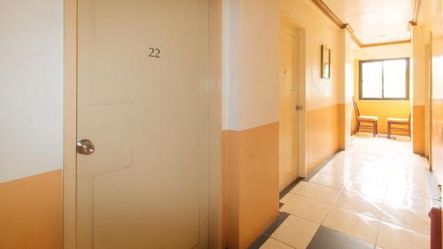 a hallway with a white door and a room at RedDoorz @ Tondaligan Beach Hotel in Dagupan
