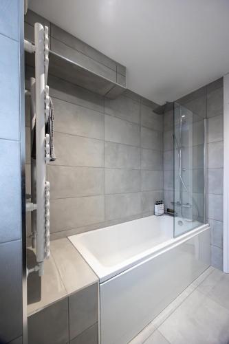 a bathroom with a tub and a glass shower at Stunning 3BR, Free Parking, near Town Center, Long term discoun in Reading