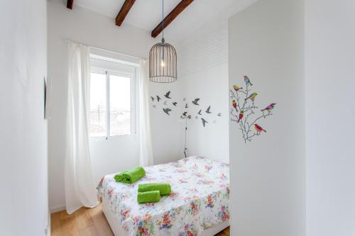 a white bedroom with a bed and a window at Apartment Ruzafa Puerto Rico in Valencia
