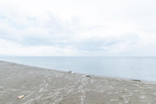 an empty beach with footprints in the sand at RedDoorz @ Tondaligan Beach Hotel in Dagupan