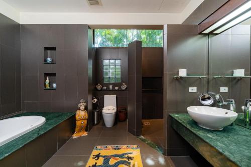 バンタオビーチにあるBaan Mandala Villa 4の浴槽、洗面台、トイレを備えたバスルーム
