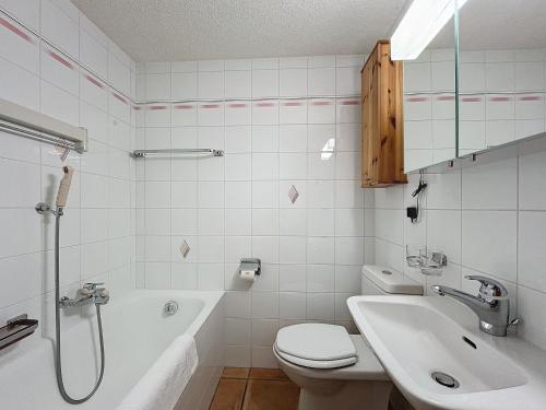 a bathroom with a toilet and a sink and a shower at Farfadet 109 in Verbier